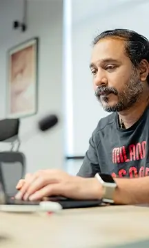 Vivasoft engineer who working at office with laptop.